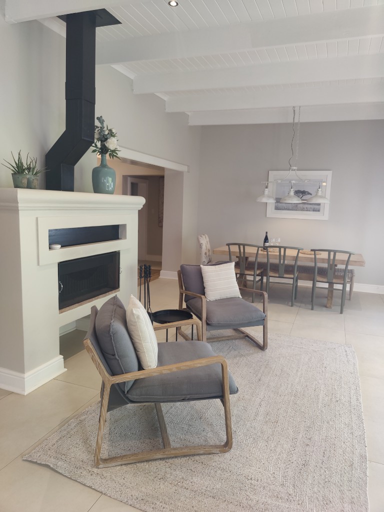 Fireplace and dining area with exposed beams